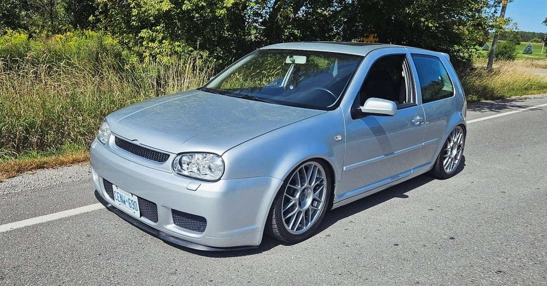 Silver bagged Volkswagen Mk4 GTI viewed from the front, with multi-spoke wheels and a low parked stance.
