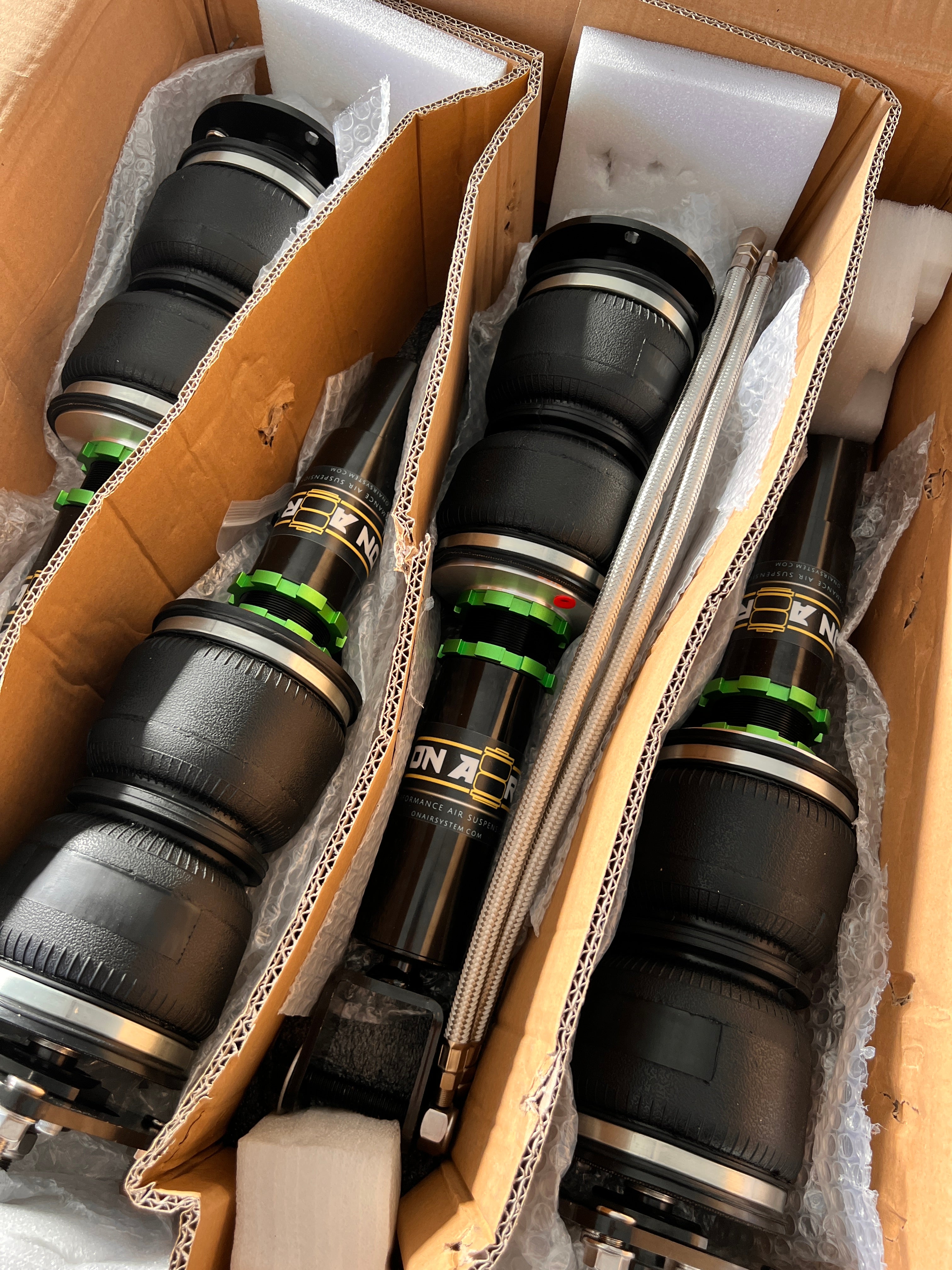 set of air suspension in the box dressed in green collar rings