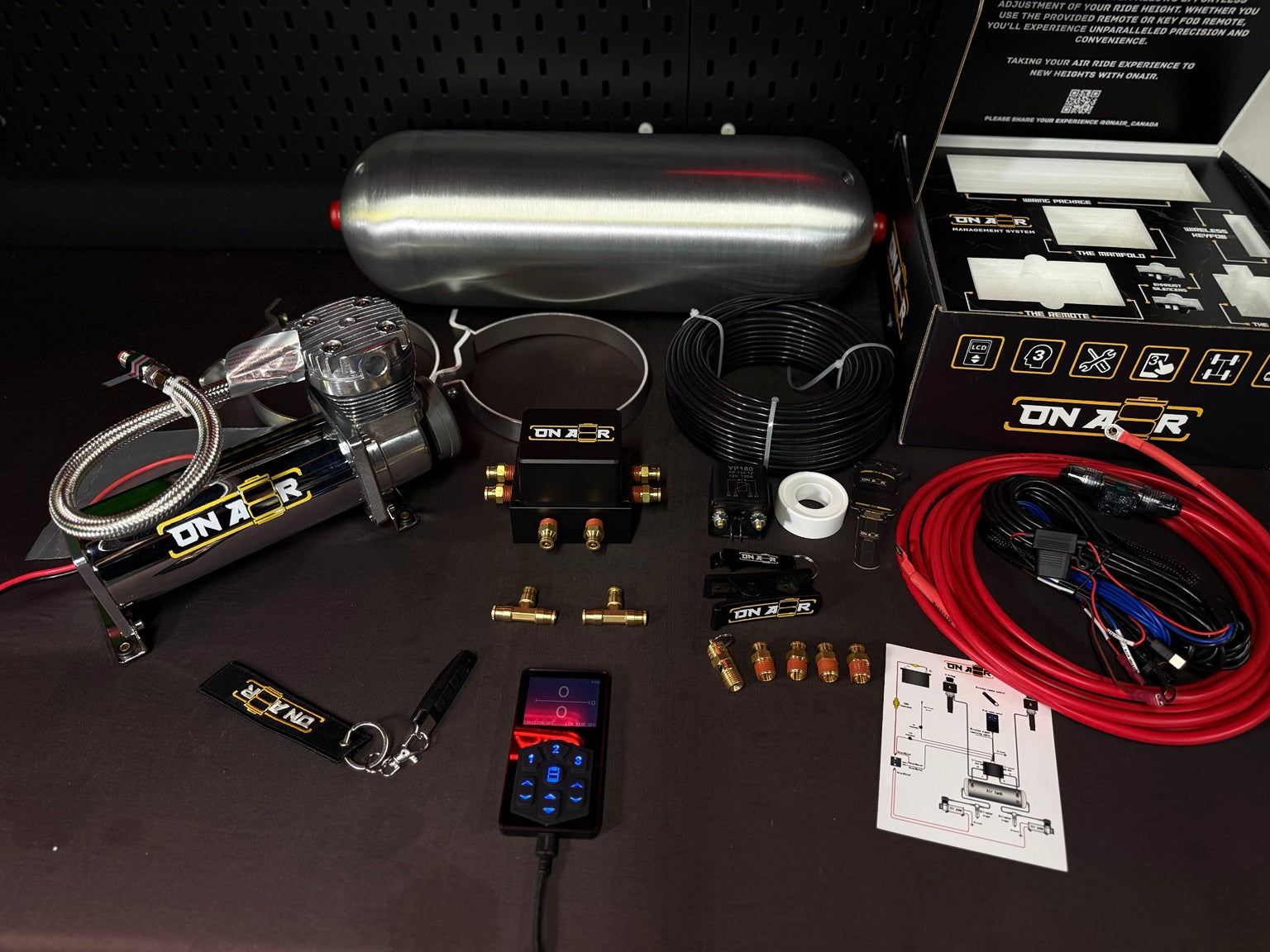 Image of ONAIR 2V controller, compact manifold and slim A–D wireless key fob shown beside a separately sold tank and compressor