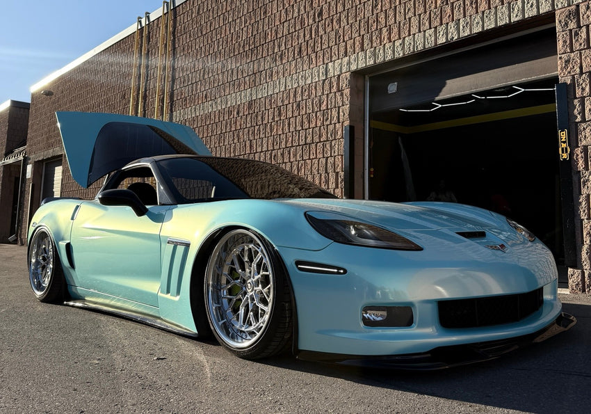 Turquoise C6 Corvette aired out outside ONAIR after its air suspension installation.