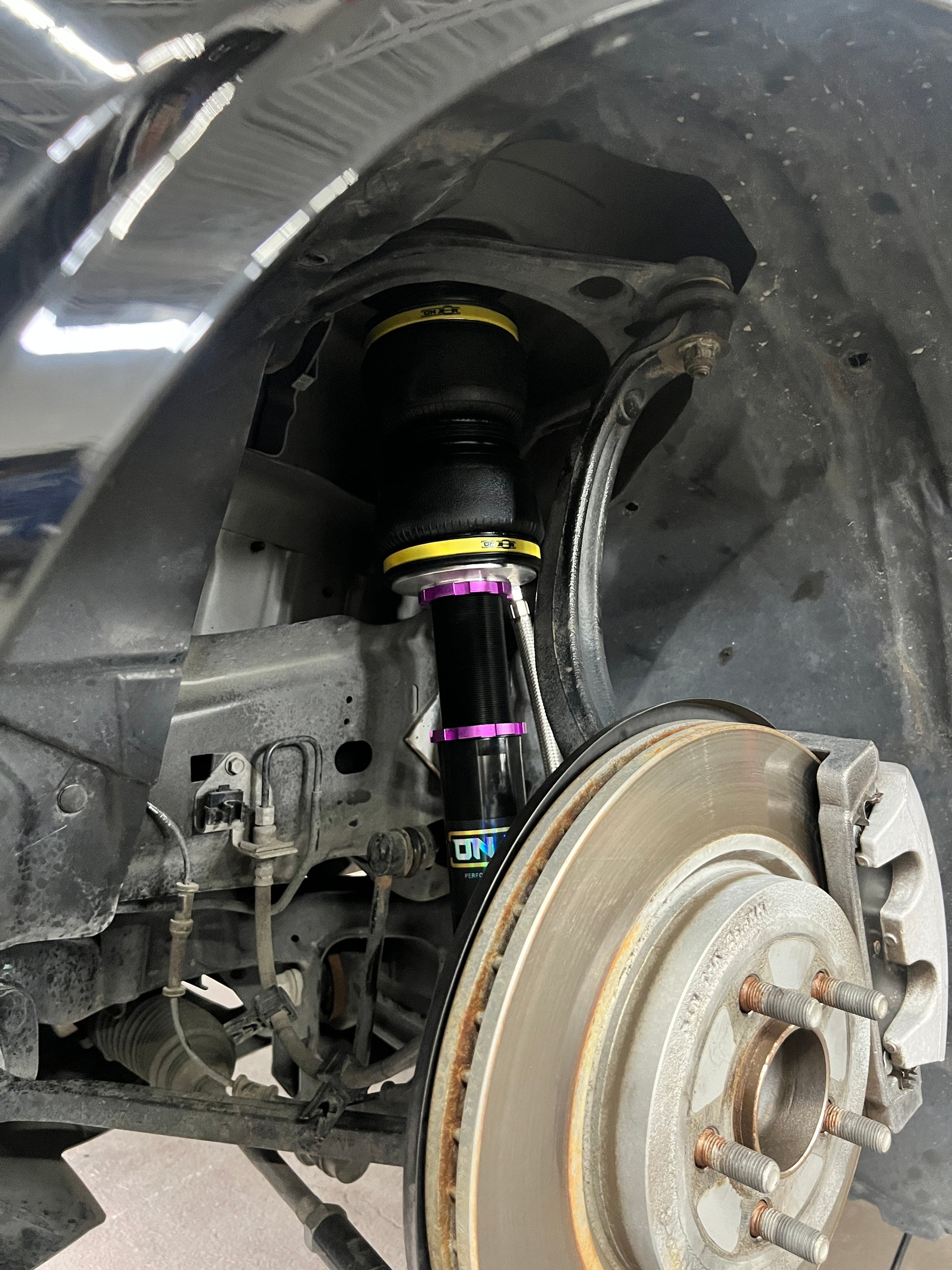 sitting perfectly inside a cars suspension is the onair performance air strut